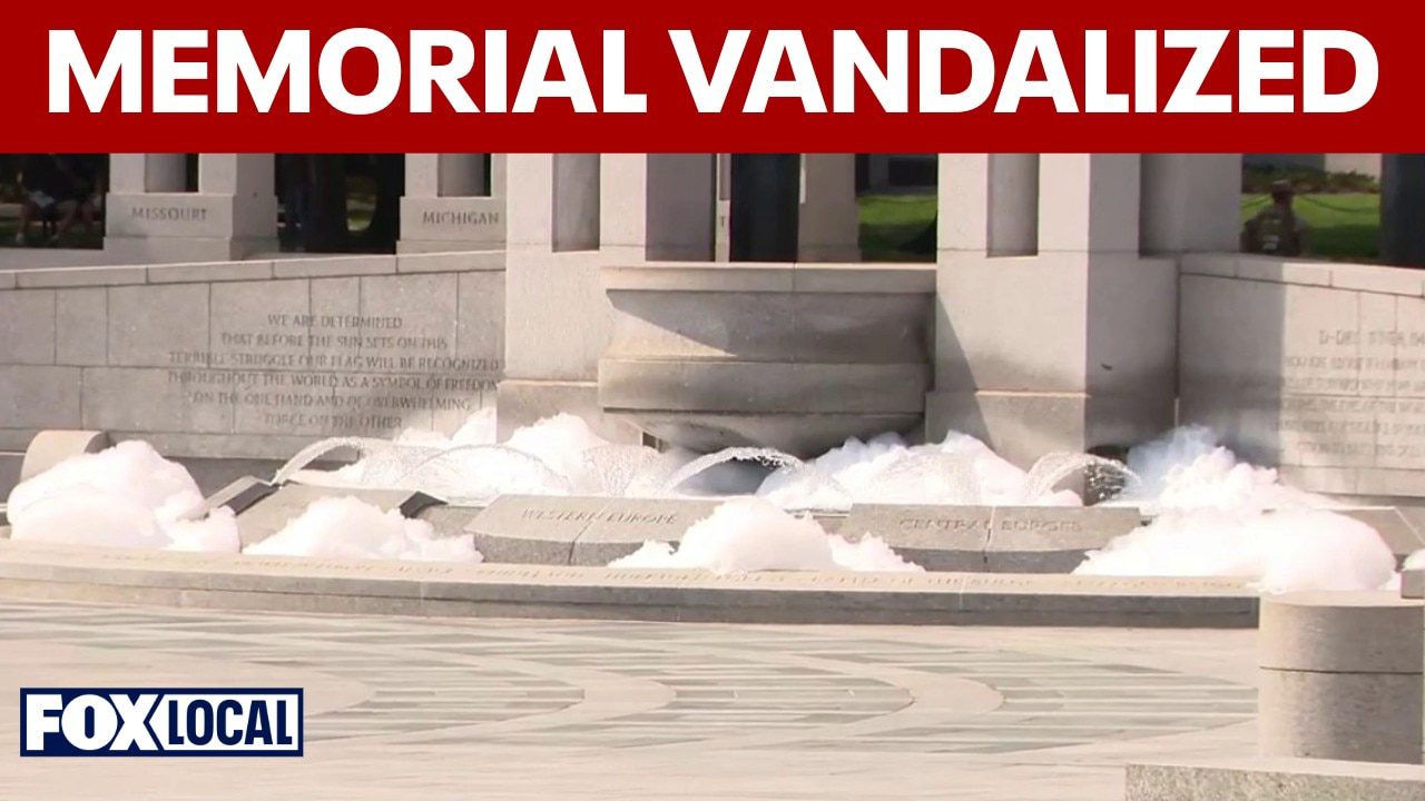 WWII Memorial fountain overflows with bubbles, vandalized with paint
